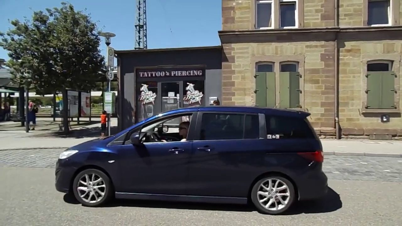 a small car parked on the side of a road