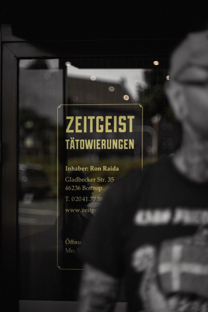 a man standing in front of a store window