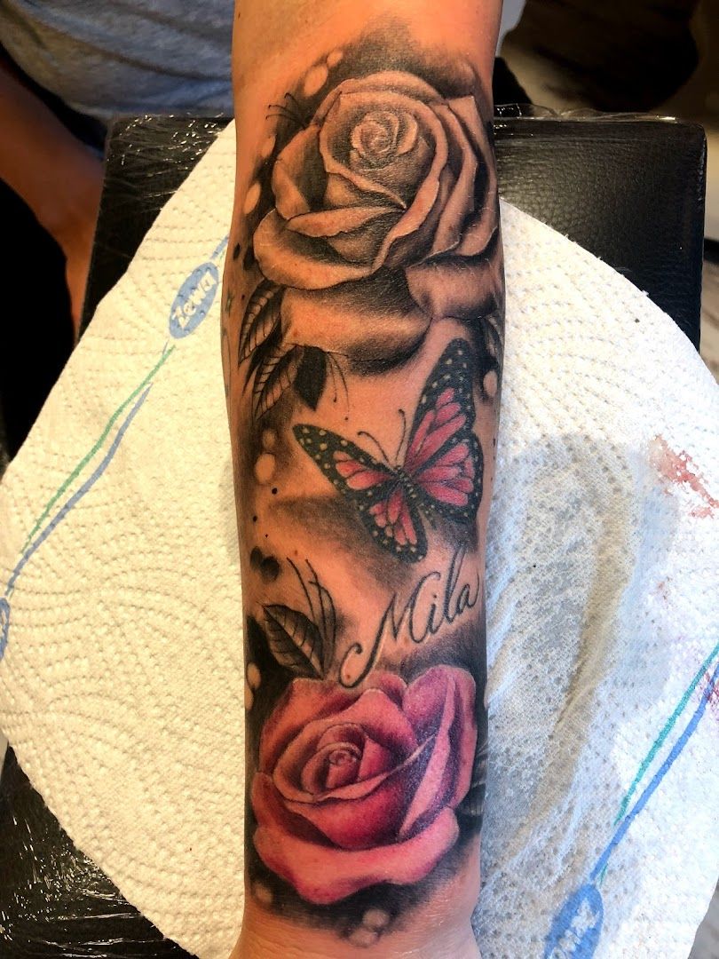 a cover-up tattoo with roses and butterflies on the arm, neu-ulm, germany