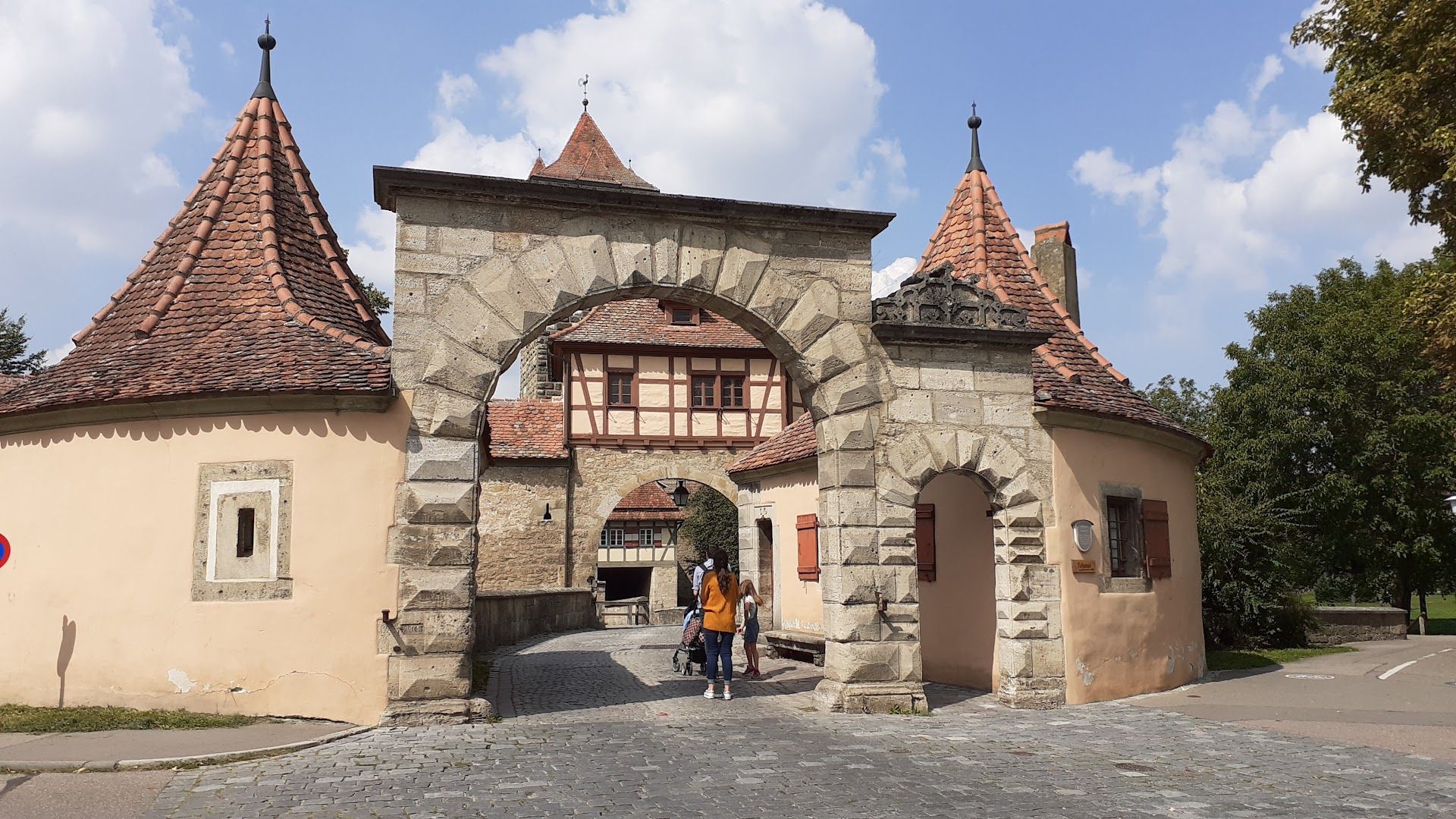 a stone building with a red roof