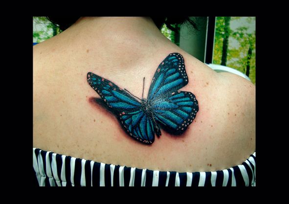 a blue butterfly cover-up tattoo on the back of a woman, rhein-sieg-kreis, germany