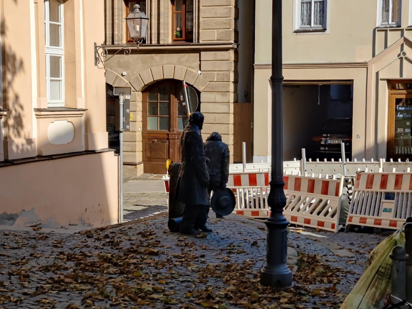 a man walking down a street with a fire hydrant