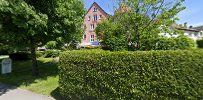 a house with a driveway and trees in the background