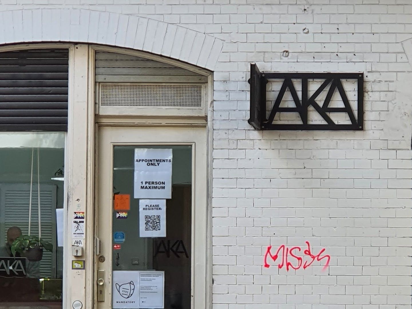 a white brick building with a sign that says,'no '