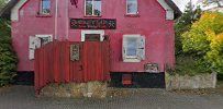 a red house with a red door and windows