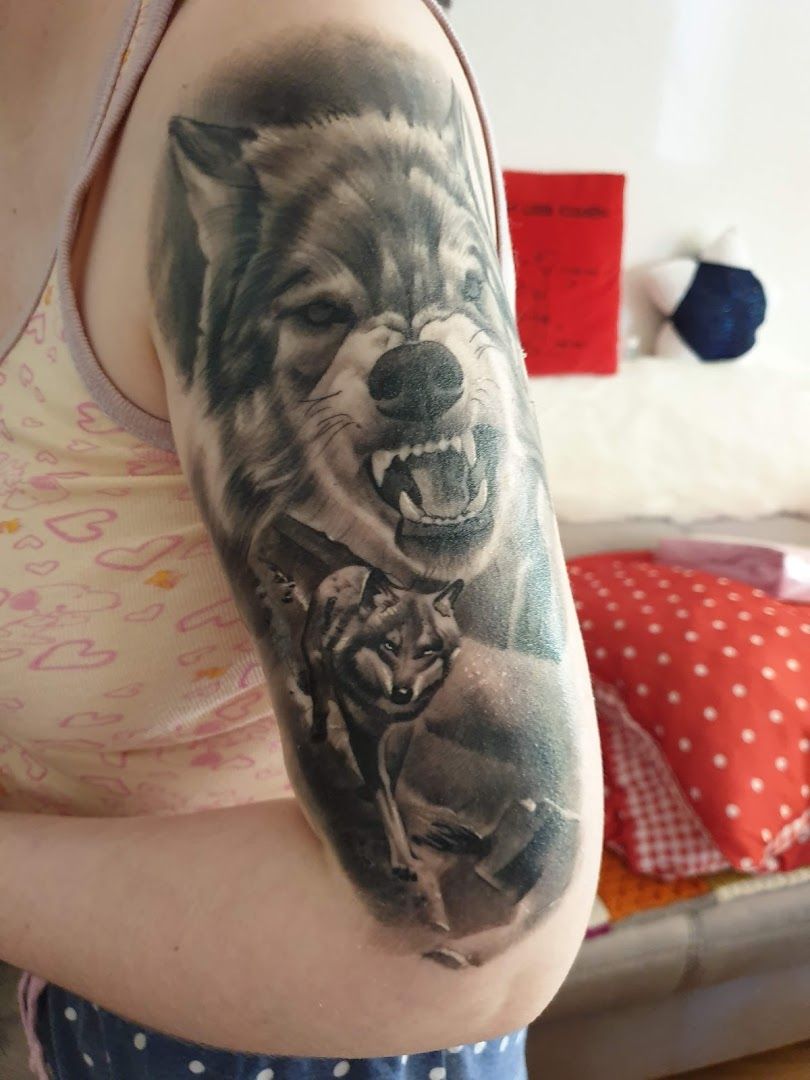 a woman with a cover-up tattoo of a dog and a cat, salzlandkreis, germany