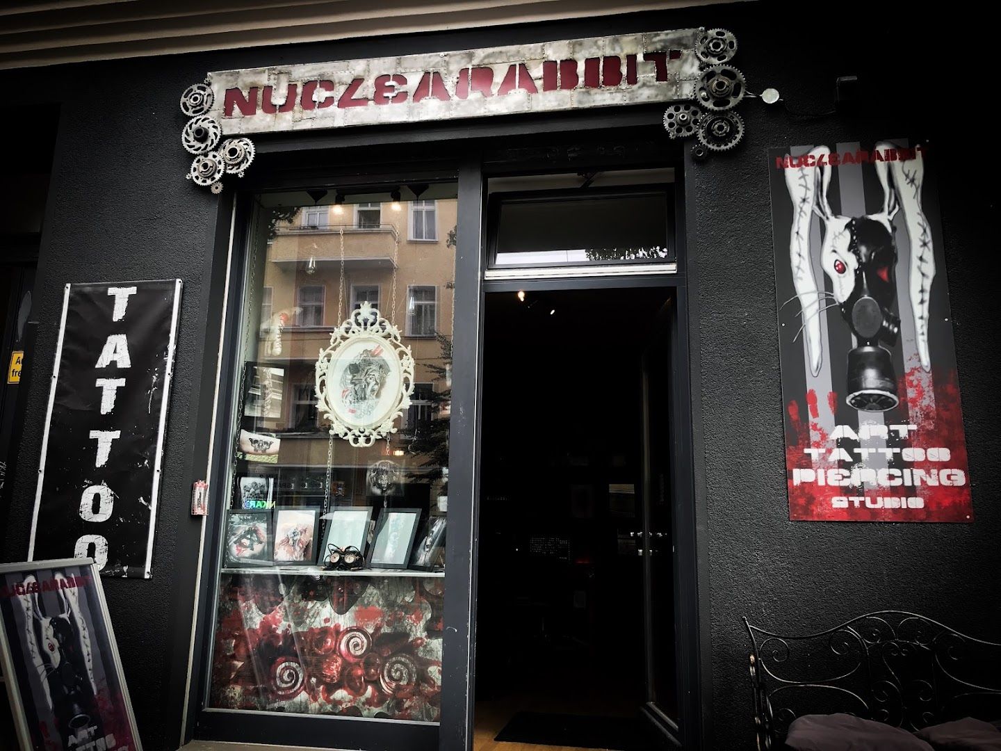 a store front with a clock and a sign