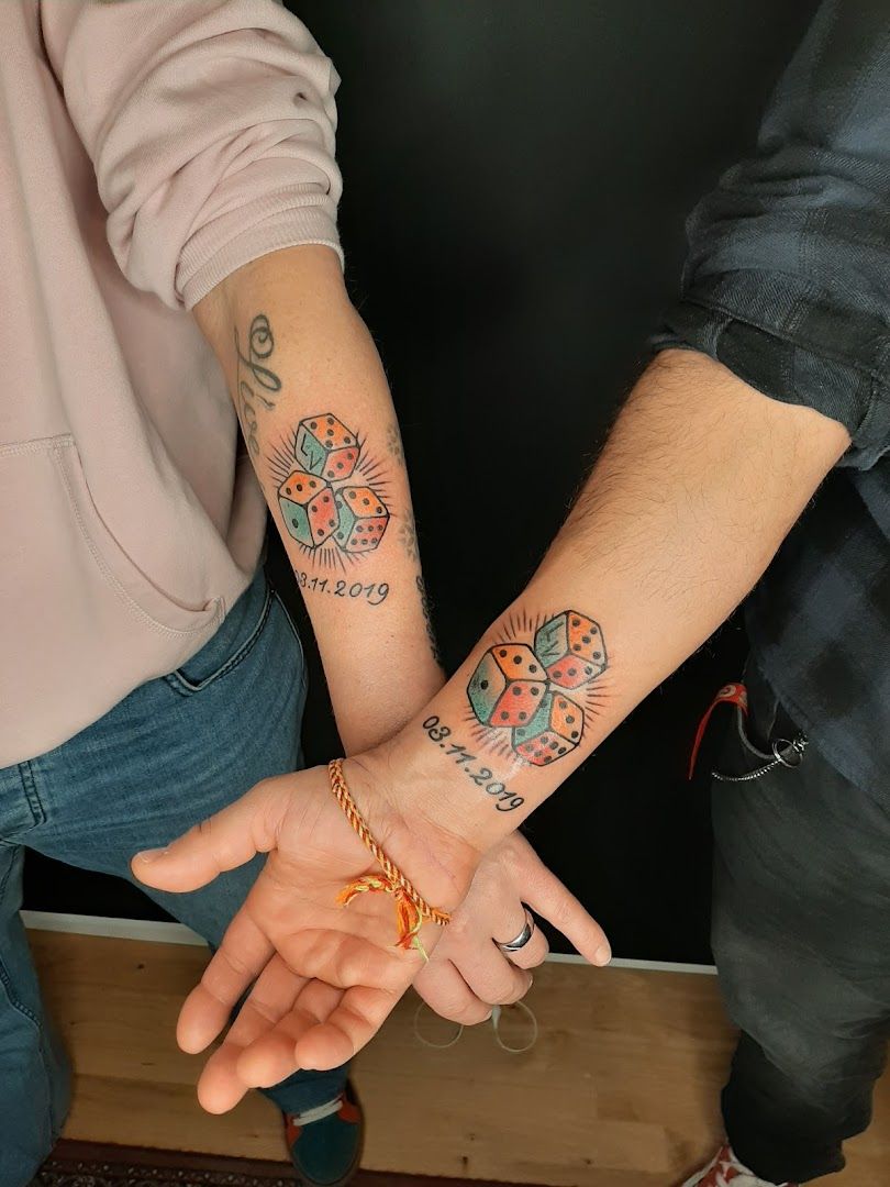 two people holding hands with narben tattoos on their wrists, stuttgart, germany