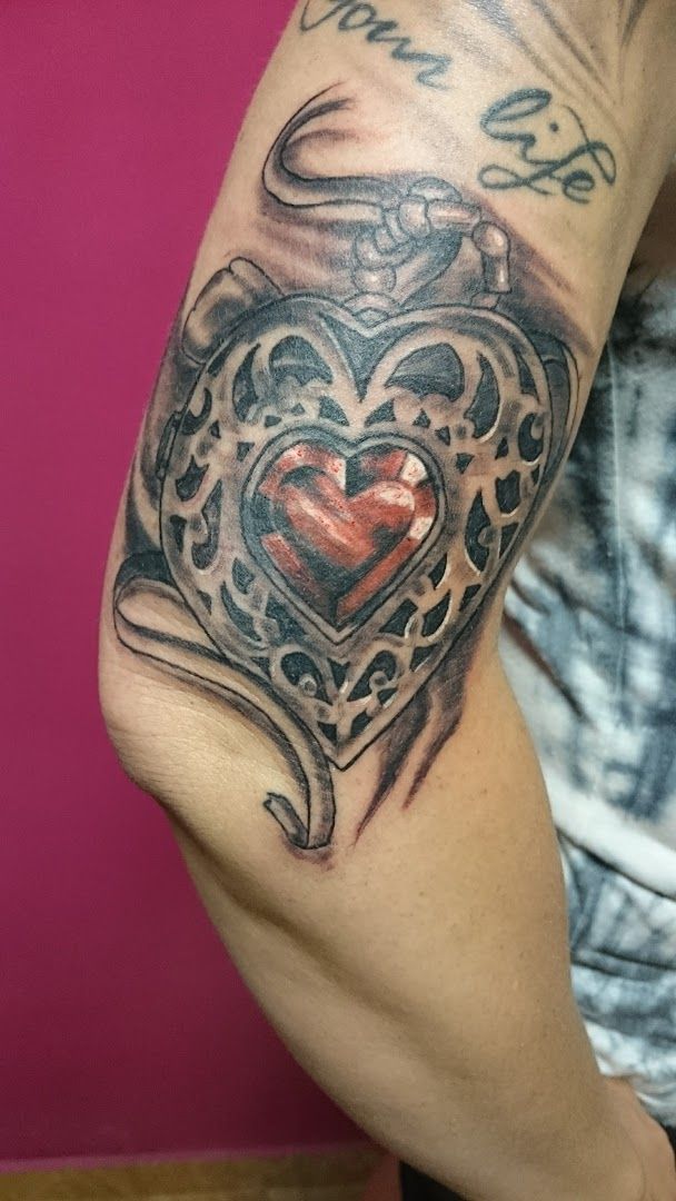 a man with a heart cover-up tattoo on his arm, görlitz, germany