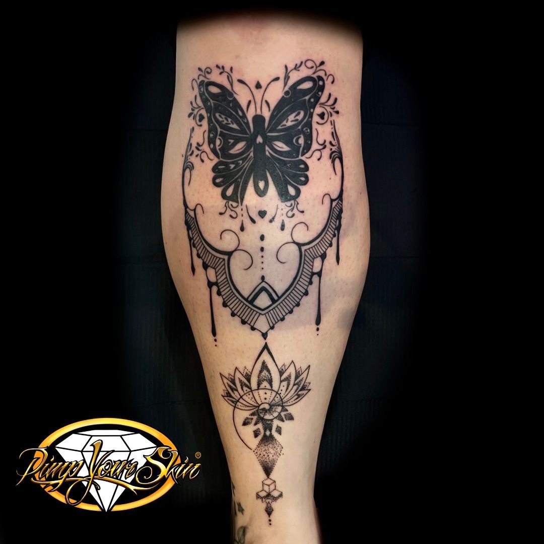 a cover-up tattoo of a butterfly with a flower on the leg, augsburg, germany