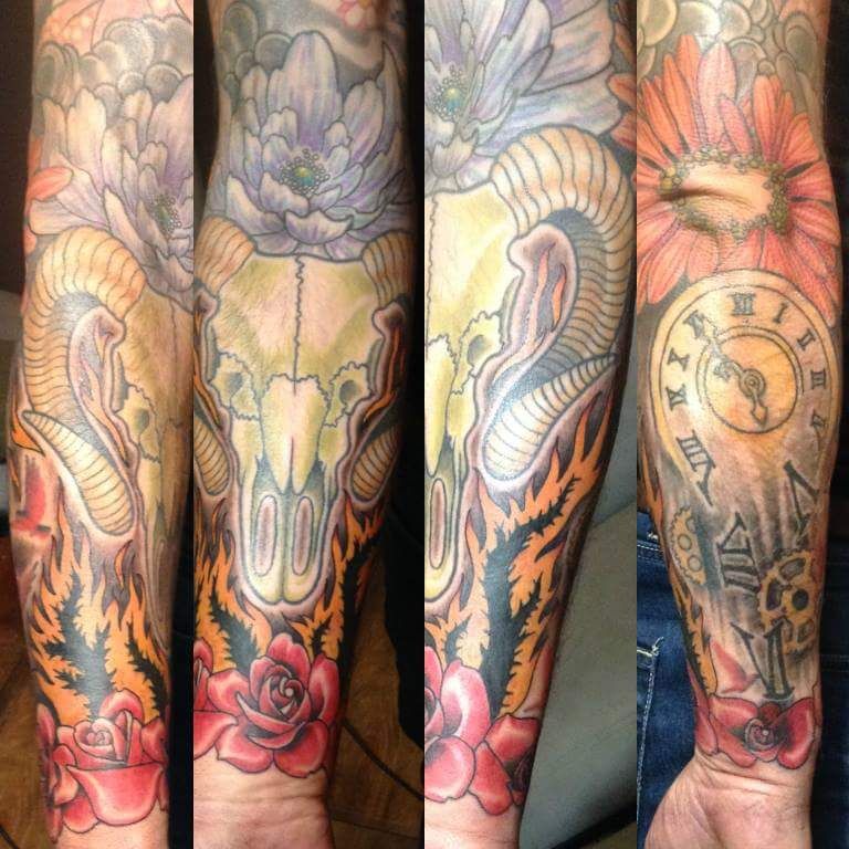 a japanische tattoos in leipzig with a skull and flowers on the arm, recklinghausen, germany