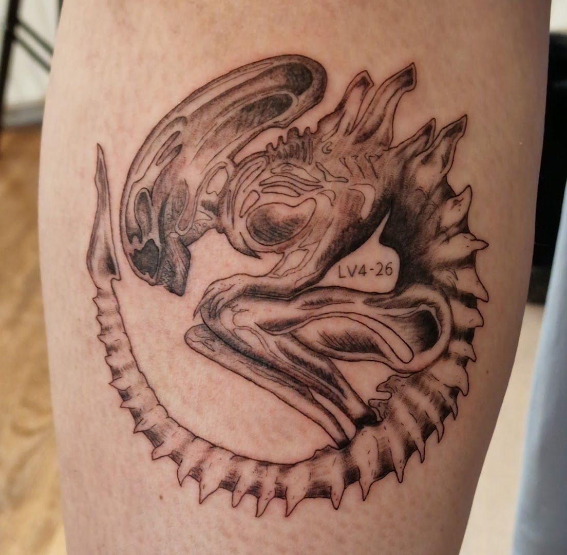 a cover-up tattoo of a dragon on the leg, hamburg, germany