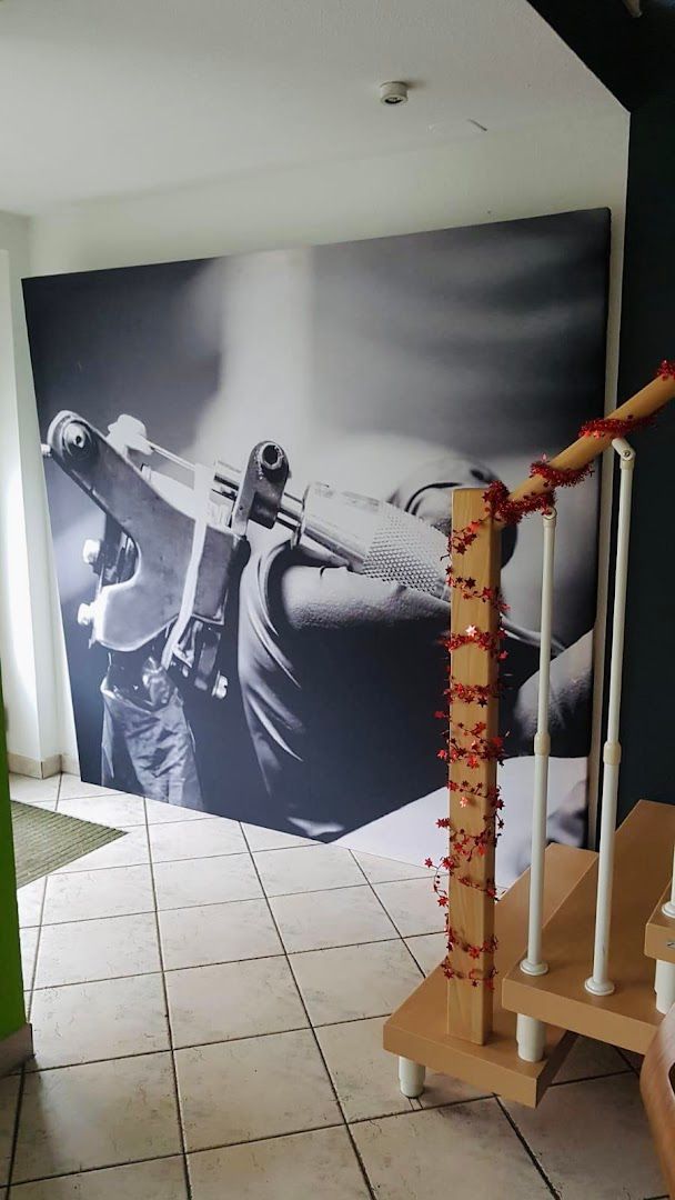 a large wall mural of a gun with blood on it