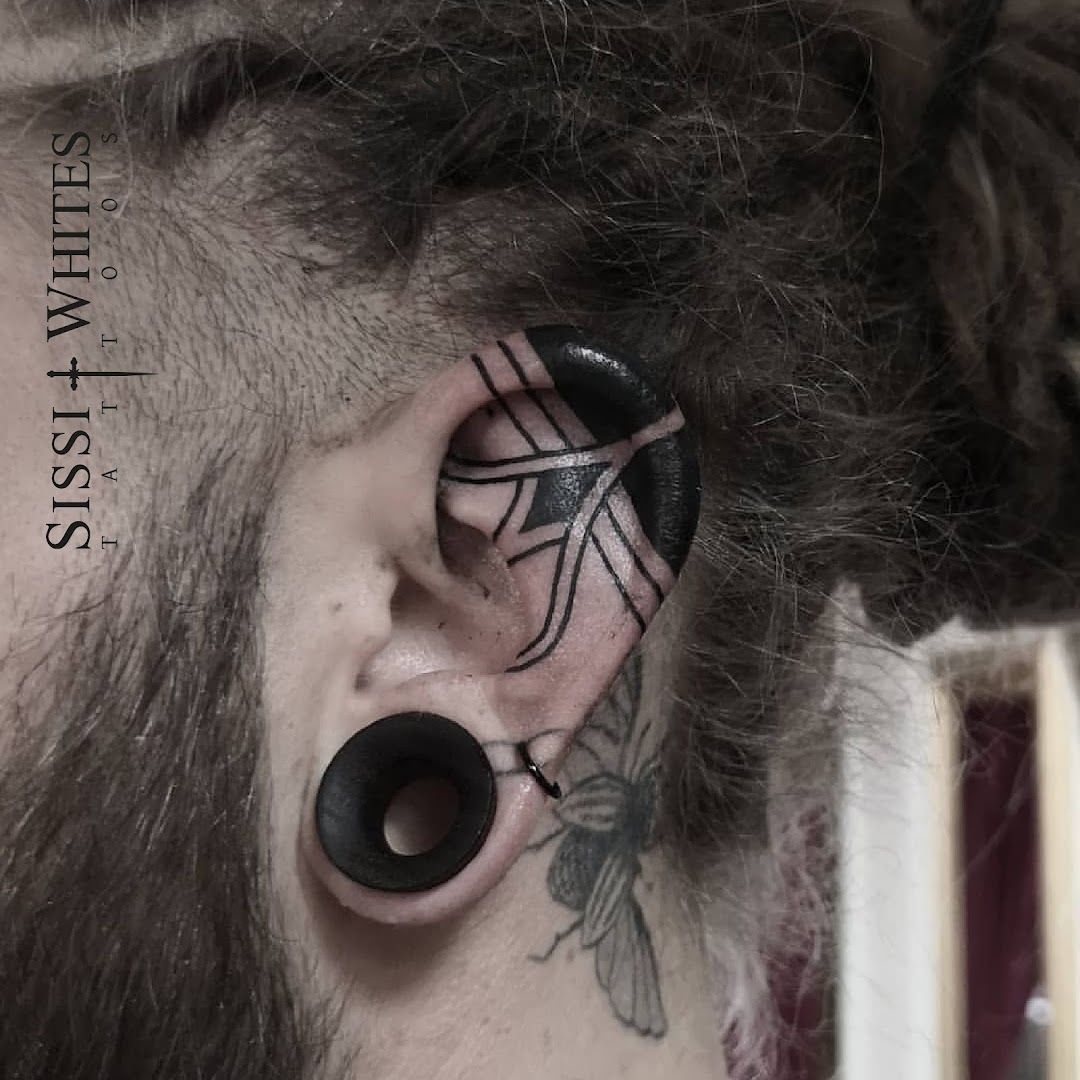 a man with a black spider blackwork tattoo on his ear, esslingen, germany