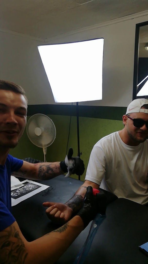 two men sitting at a table with a fan