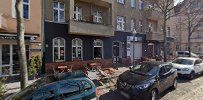 a street with parked cars and buildings