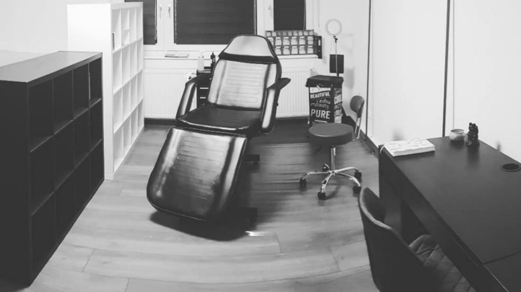 a black and white photo of a desk and chair