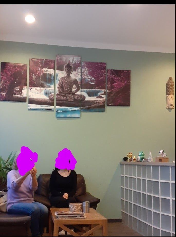 two people sitting on a couch in a room