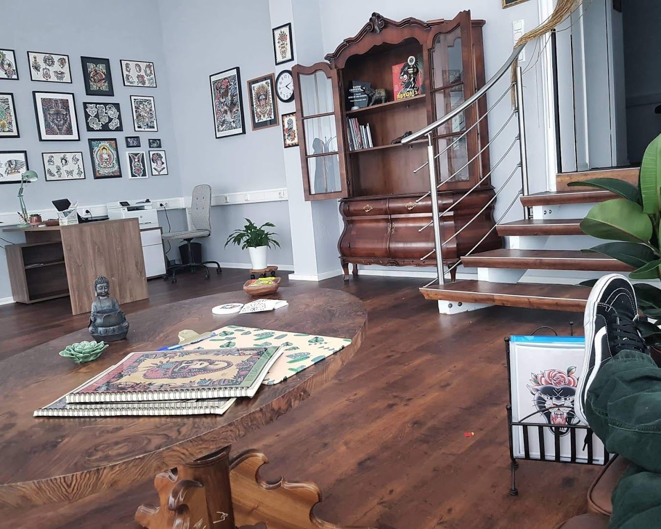 a living room with a wooden floor and a wooden table