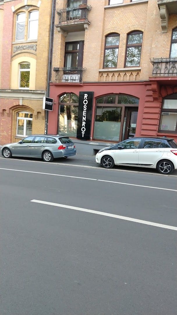 a street with cars parked on it and a building in the background