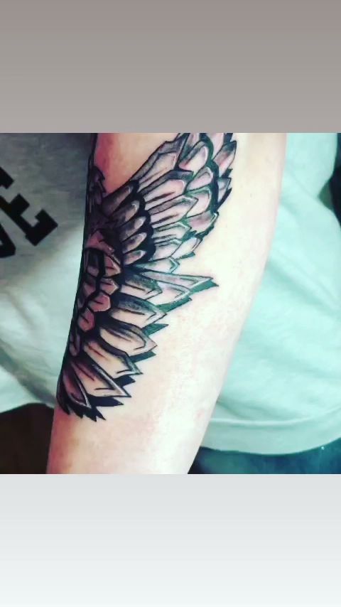 a black and white narben tattoo with a wing, märkischer kreis, germany