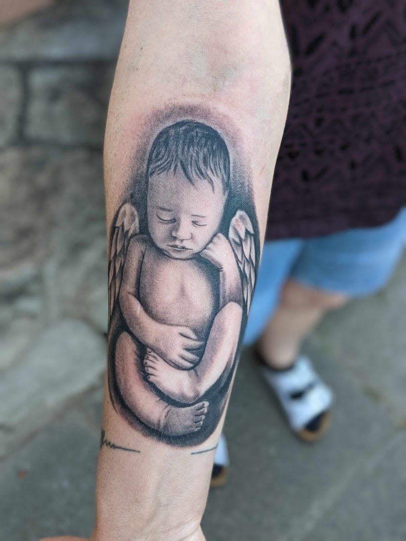a narben tattoo of an angel holding a baby, darmstadt-dieburg, germany