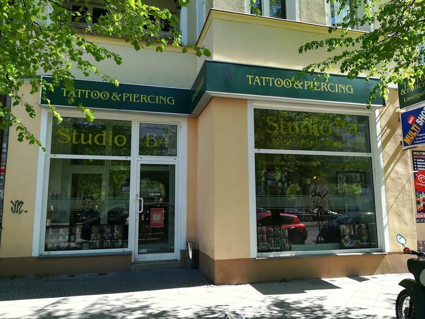 a building with a sign that says narben tattoo and piercing, berlin, germany