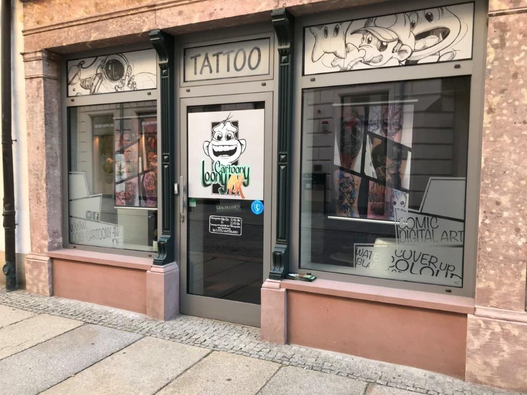 a storefront with graffiti on the windows