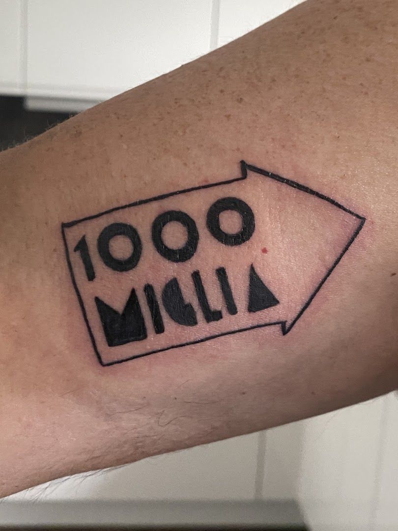 a cover-up tattoo with the word'100'on it, dachau, germany