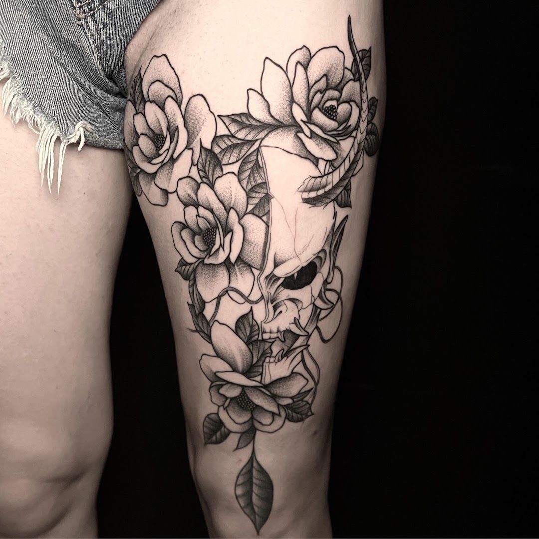 a woman's thigh with a skull and roses cover-up tattoo, nürnberg, germany