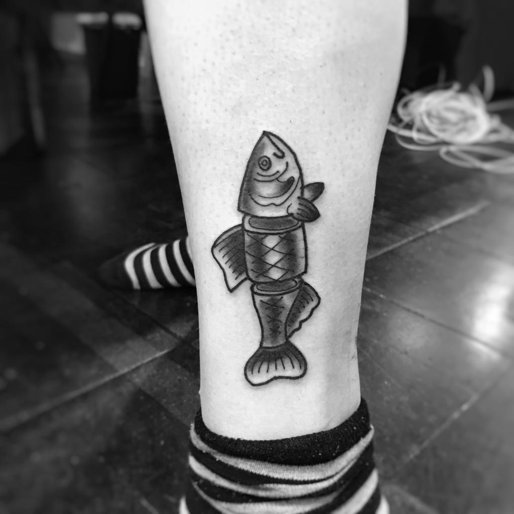 a small fish cover-up tattoo on the ankle, berlin, germany