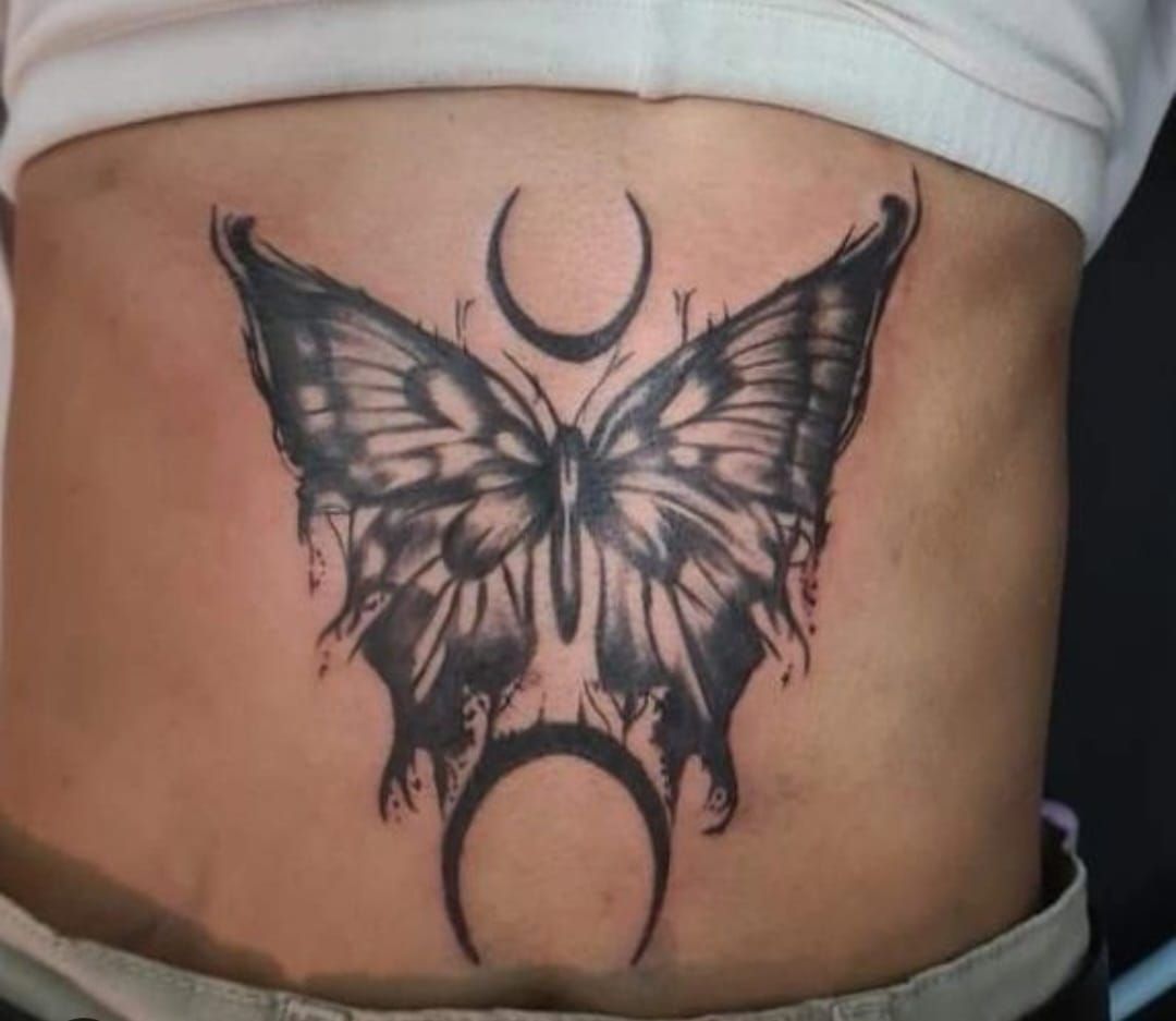 a butterfly cover-up tattoo on the side of a woman, neustadt an der waldnaab, germany