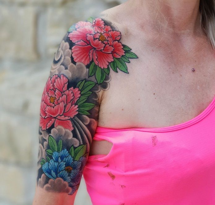 a woman with a pink shirt and a narben tattoo on her arm, bodenseekreis, germany