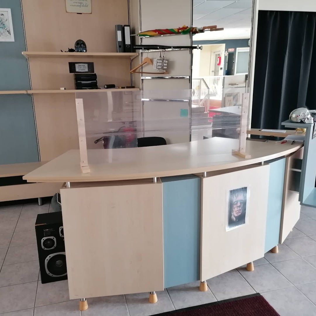 a small kitchen with a counter and shelves