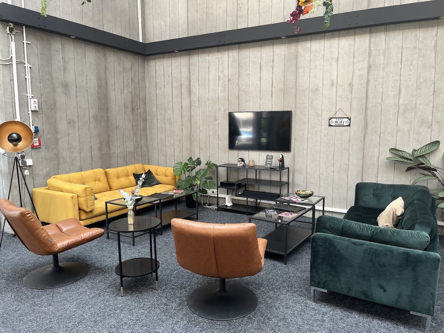 a living room with a couch, chairs, and a television