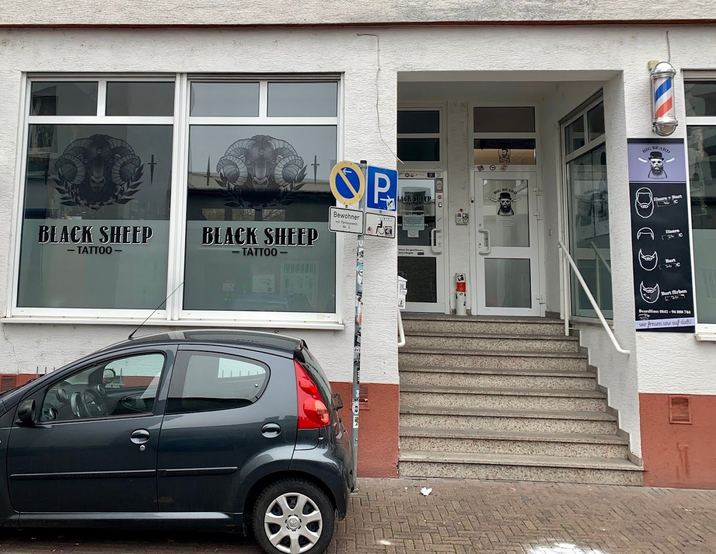 a small car parked in front of a building