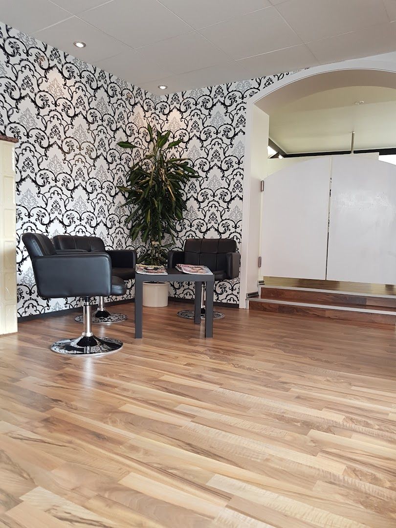 a salon with a large wallpaper and chairs