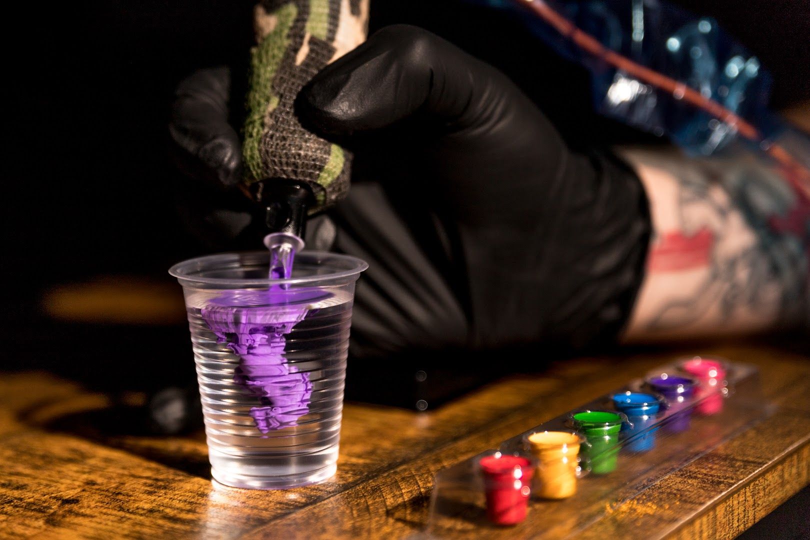 a person in black gloves and gloves is playing with dice