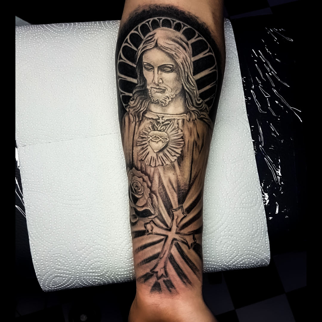 a cover-up tattoo of a woman with a cross on her arm, mönchengladbach, germany