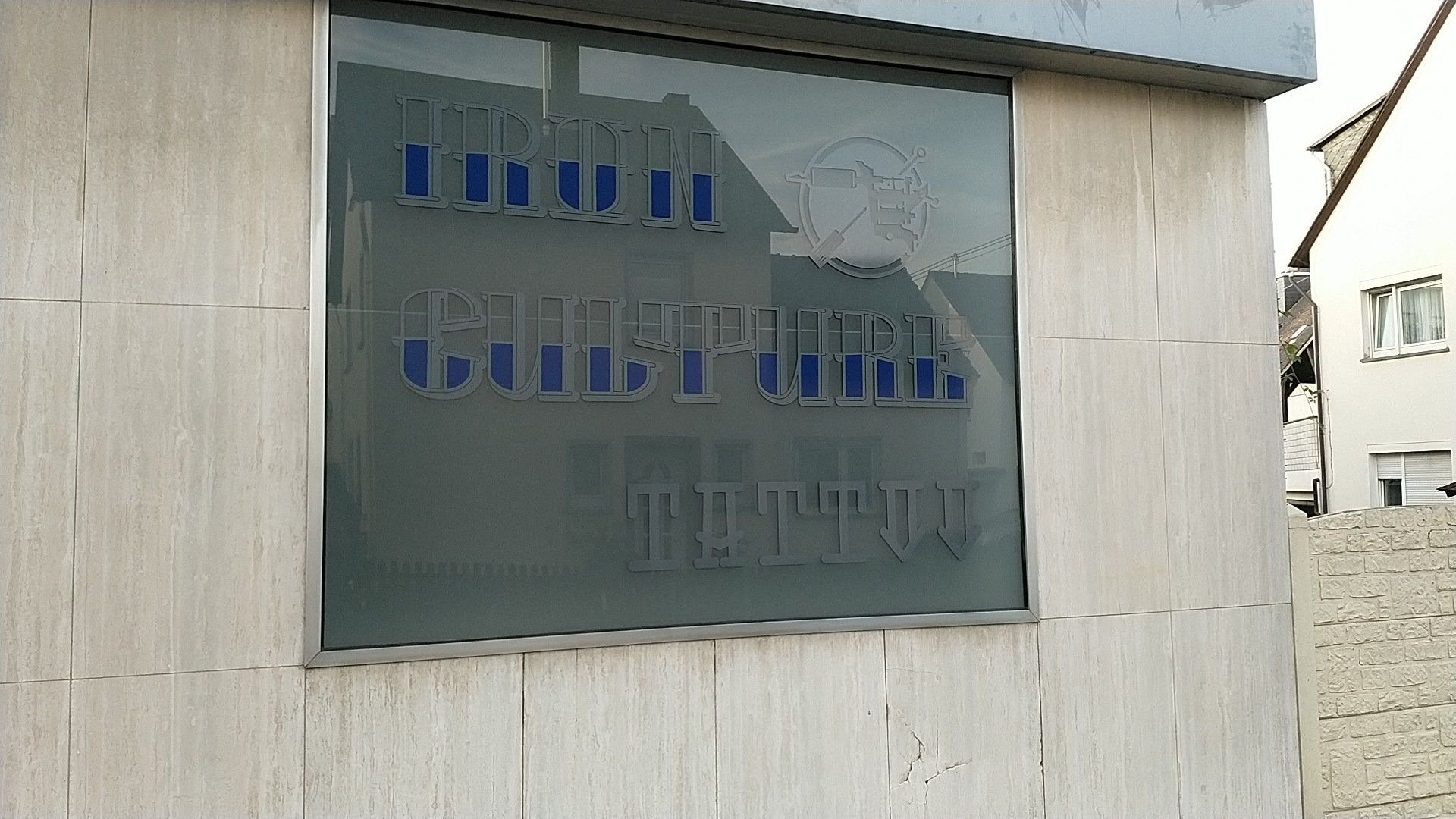 a building with a sign that says the building is made of glass