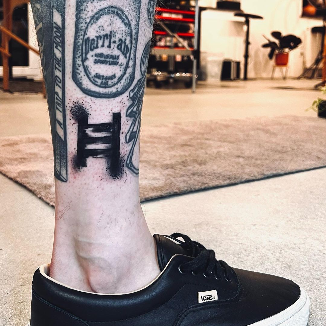 a cover-up tattoo on the leg of a man with a stamp stamp on his leg, bochum, germany