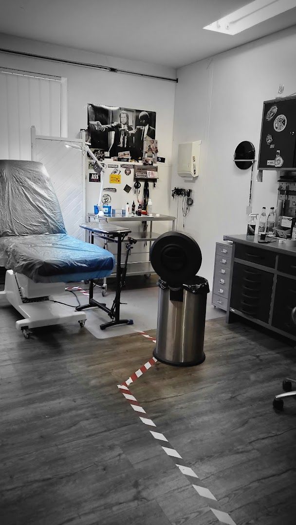 a room with a bed, chair and a desk