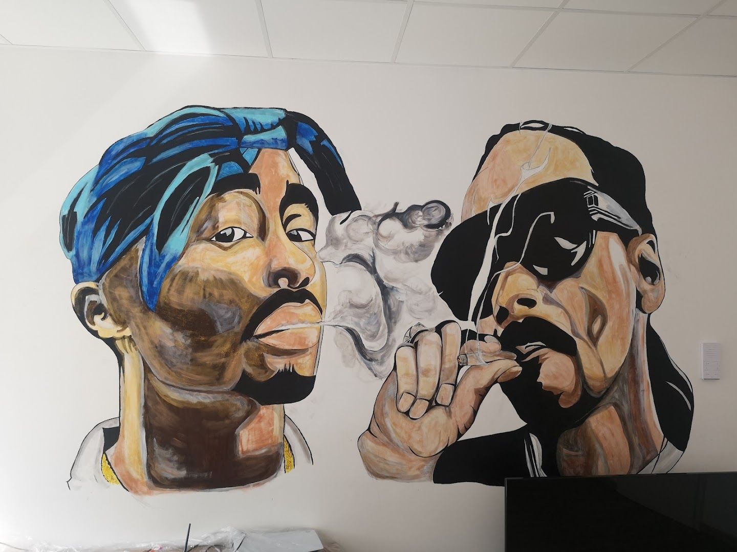 a mural of two men smoking cigarettes