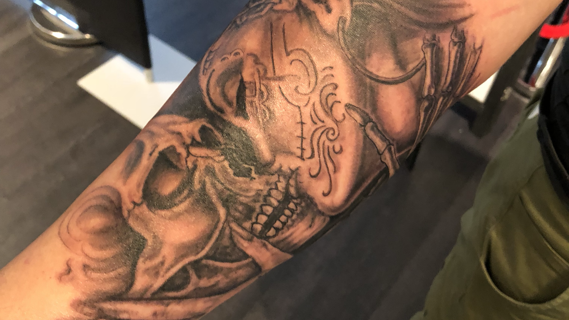 a trashpolka tattoos of a skull and a skull on the arm, dillingen, germany