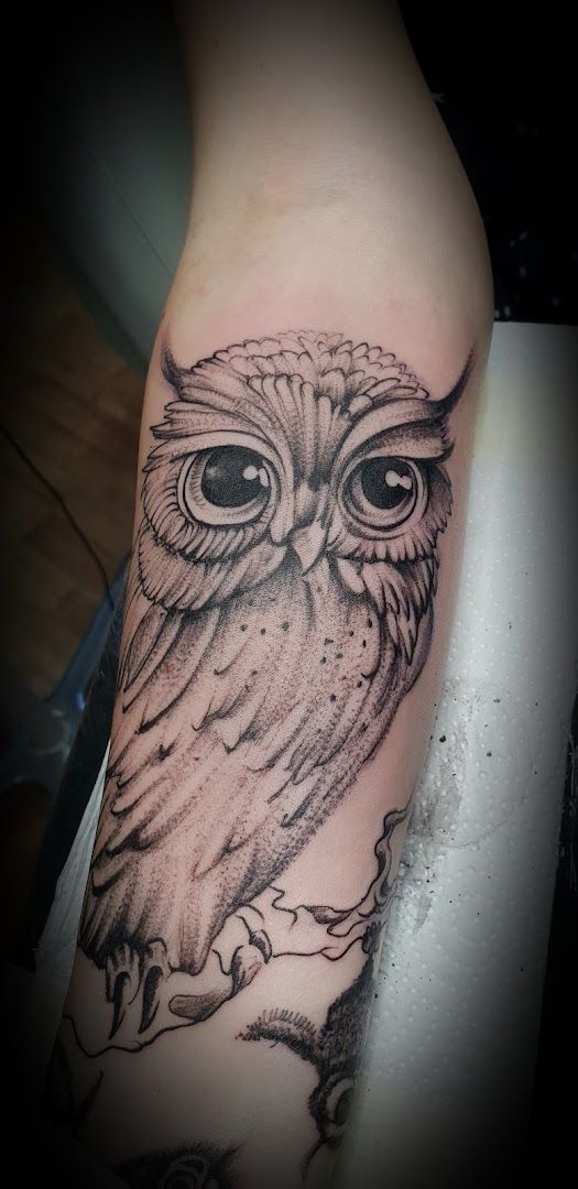 an owl cover-up tattoo on the arm, uckermark, germany