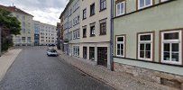 a street with buildings and a car parked on the side