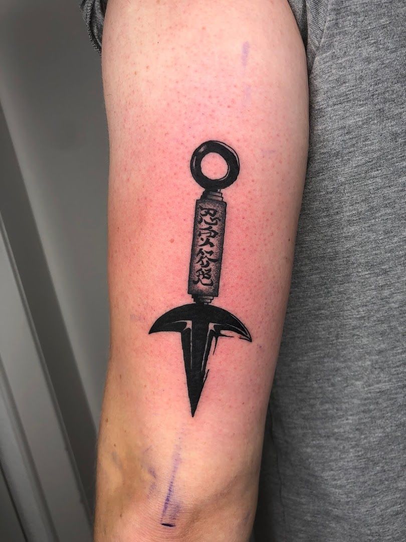 a knife cover-up tattoo on the arm, düsseldorf, germany