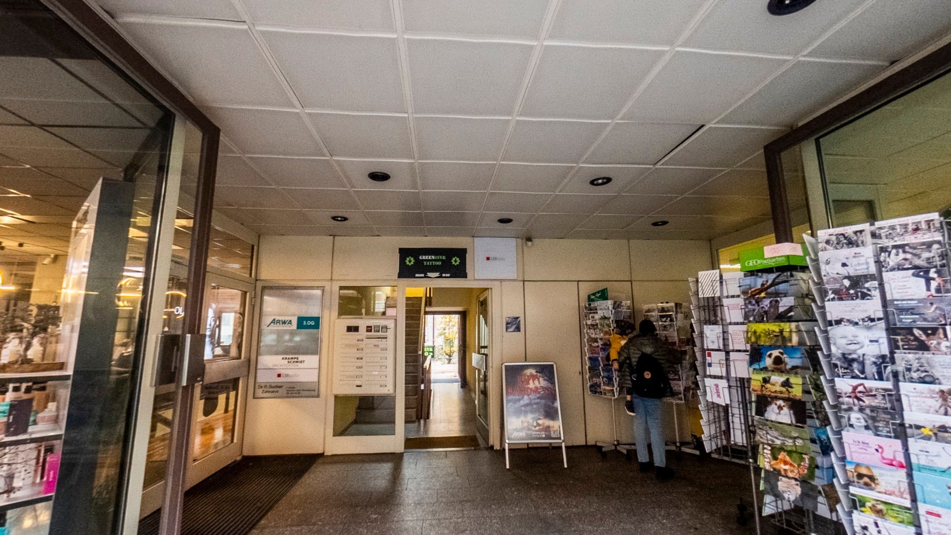 a hallway with a bunch of posters on the wall