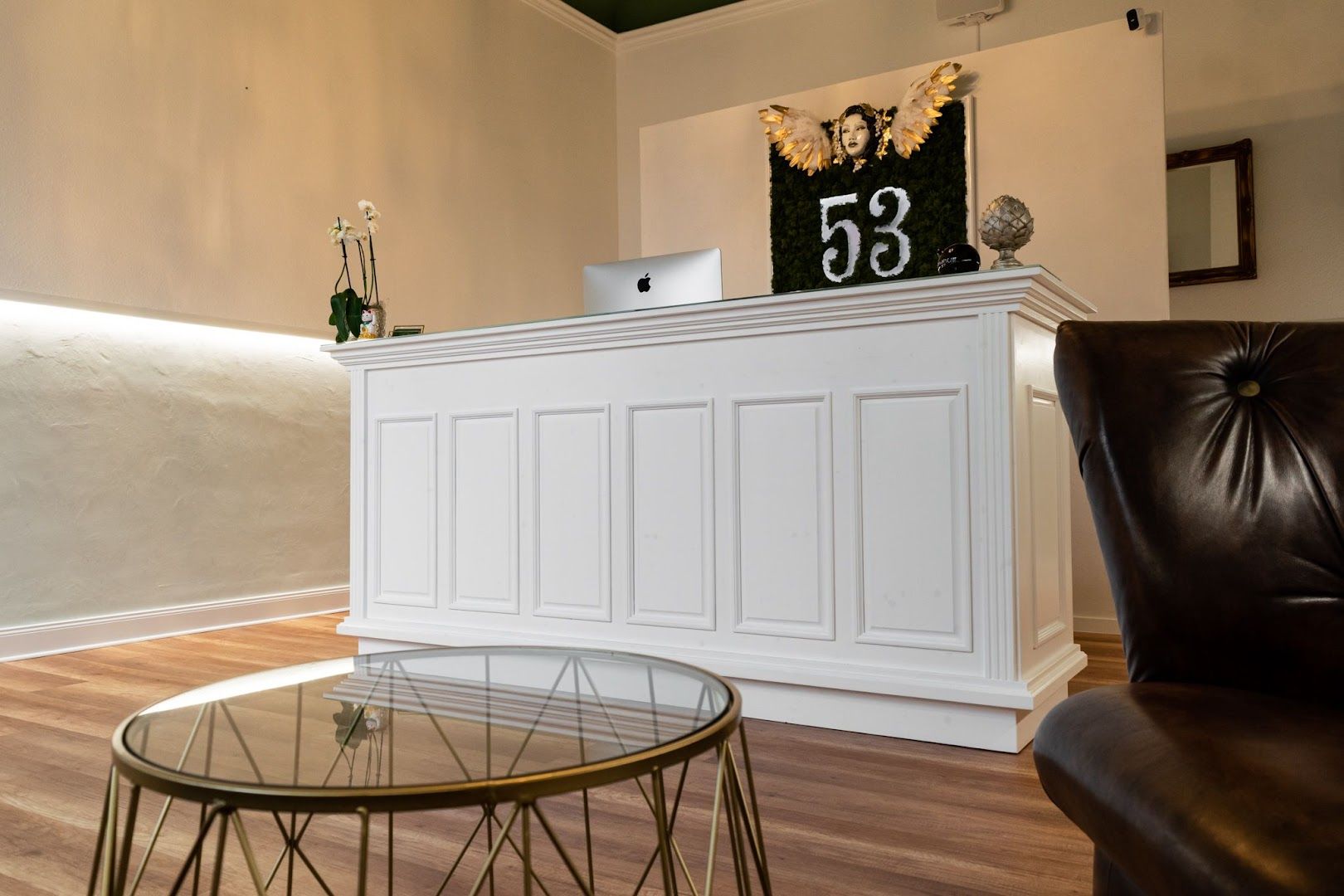 a white reception table with a clock on top