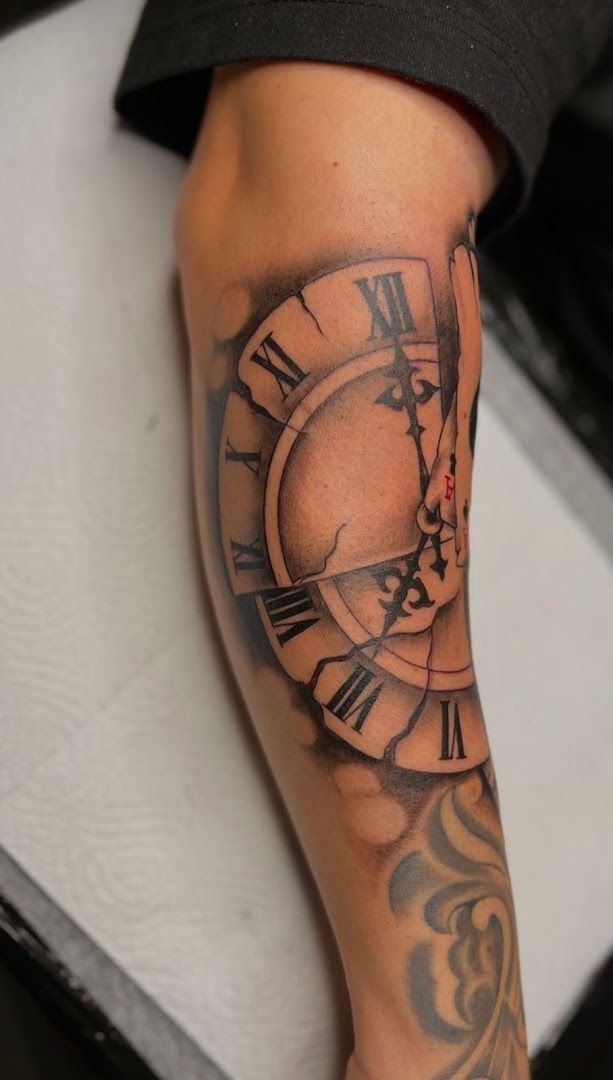 a clock cover-up tattoo on the arm, duisburg, germany